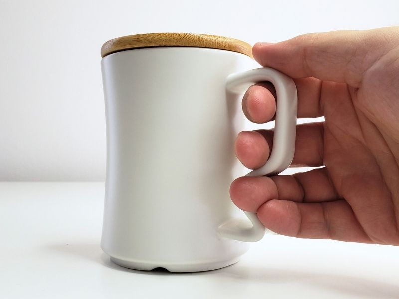 Hand Holding an Ergonomic Momnt Mug